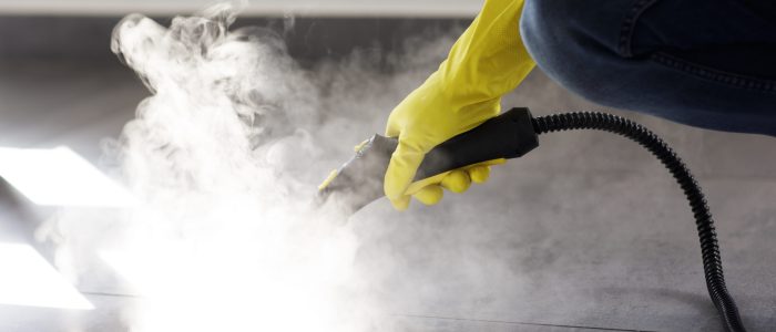 professional-cleaning-service-person-using-steam-cleaner-office